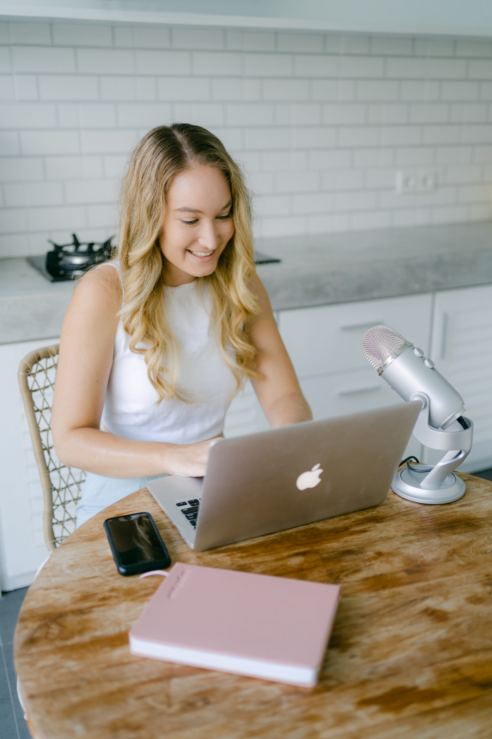 Social media manager creating a portfolio on a laptop